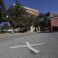 Crime scene: An X marks the spot on Elm Street where the fatal bullet struck U.S. President John F. Kennedy on Nov. 22, 1963, near the former Texas School Book Depository in Dallas. | AP