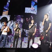 Rock you: One Direction (left-right: Liam Payne, Louis Tomlinson, Zayn Malik, Harry Styles and Niall Horan) performs for fans at Chiba’s Makuhari Messe convention center on Saturday. One Direction takes the J-pop path to success