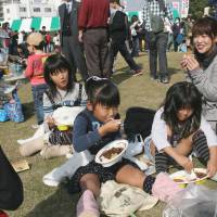 Spice of life: Families enjoy various curries at the Tsuchiura Curry Festival. | REBECCA MILNER