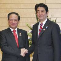 Connectivity: ASEAN Secretary-General Le Luong Minh is greeted by Prime Minister Shinzo Abe ahead of their meeting Tuesday in Tokyo. Minh is on a four-day visit to Japan to prepare for a Dec. 13-15 ASEAN special summit to mark 40 years of diplomatic ties. | KYODO