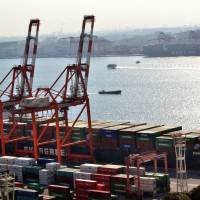 Moving freight: A containership docks Monday at the international cargo terminal in Tokyo. The latest government data shows that the current account surplus rose in the first six months of fiscal 2013, the first expansion in six half-year periods. Key trade gauge logs surprise rise in half