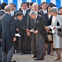 Controversial gambit: Upper House lawmaker Taro Yamamoto hands a letter to Emperor Akihito (center) during the autumn garden party at the Akasaka Palace Imperial Garden on Thursday. | POOL