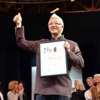 How sweet it is: Hironobu Tsujiguchi gives the thumbs-up sign after receiving the highest award at the Salon du Chocolat global chocolate fair in Paris on Thursday. | KYODO