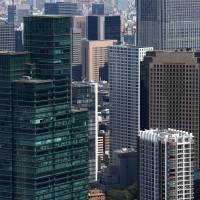 Office space: Commercial and residential buildings are seen from the observatory of the Mori Building Co.-operated Roppongi Hills Mori Tower on Sept. 3. The office vacancy rate in Tokyo fell in October to its lowest level in more than four years. | BLOOMBERG