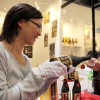 Taste of Japan: An employee of Kagoshima-based \"shochu\" spirits maker Tensei Shuzo offers a sample to a visitor at a trade fair in Hong Kong on Thursday. | KYODO