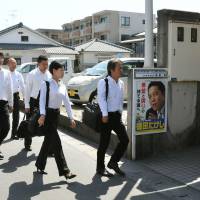 Knock, knock: Investigators from the Tokyo Prosecutor\'s Office enter the Kagoshima home of Torao Tokuda, father of Liberal Democratic Party lawmaker Takeshi Tokuda and founder of the Tokushukai hospital and welfare chain, on Tuesday | KYODO