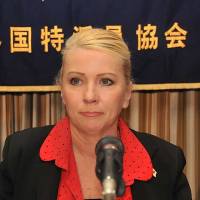 With tears in her eyes, Catherine Fisher, the victim of a 2002 rape by an American serviceman near the U.S. Navy base in Yokosuka, pauses during a news conference Thursday at the Foreign Correspondents’ Club of Japan in Tokyo. U.S. sailor's rape victim wins case