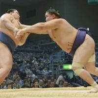 No job for the timid: Shotenro bulldozes Masunoyama at the Kyushu Grand Sumo Tournament on Friday in Fukuoka. | KYODO
