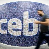Teenage wasteland: A man walks past a Facebook logo created from pictures of users worldwide at the company’s data center in Lulea, Sweden, on Nov. 7 Teenagers deserting Facebook as mom and dad join social network