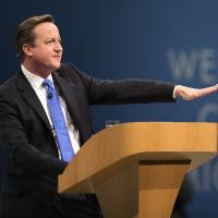 Calm Cameron: British Prime Minister David Cameron, addresses delegates at the Conservative Party\'s annual conference in Manchester, England, on Oct. 2. Cameron has urged \"sensible and calm language\" on the Roma issue | BLOOMBERG