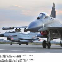 Show of force: Chinese fighter jets are seen in May in a photo provided by Xinhua News Agency. China said Saturday any aircraft entering its air defense identification zone must obey its rules or face \"defensive emergency measures.\" | KYODO