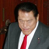 In hot water: Upper House lawmaker Antonio Inoki leaves the chamber after a resolution was passed Wedneday to punish him for visiting North Korea without permission. | KYODO