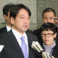 On the same page: Defense Minister Itsunori Onodera speaks to reporters after talking by phone with U.S. Defense Secretary Chuck Hagel. | KYODO