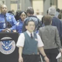 Terrorist or just tired?: TSA officials check passengers entering a security checkpoint at Atlanta\'s international airport. | AP