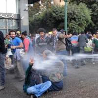 Dousing the ire: Egyptian police fire water cannons to disperse a protest by secular anti-government activists in Cairo on Tuesday. | AP