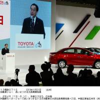 Toyota Senior Managing Officer Hiroji Onishi speaks at the automaker\'s presentation during the Guangzhou International Automobile Exhibition on Thursday. | KYODO