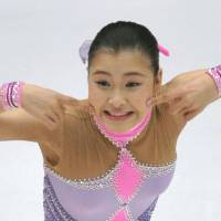 Say cheese: Kanako Murakami performs her short program routine at the Cup of China in Beijing on Friday night. | KYODO