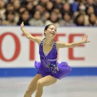 Graceful presence: Akiko Suzuki earns 66.03 points for her short program routine at the NHK Trophy on Friday, putting her in second place behind Mao Asada. | AFP-JIJI