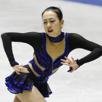 Building momentum: Mao Asada performs her free-skate routine at the NHK Trophy in Tokyo on Saturday. Mao won the competition and qualified for the Grand Prix Final. | KYODO