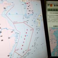 Conflicting claims: Computer screens display a map showing the outline of China’s new air defense zone in the East China on the website of the Chinese Ministry of Defense in Beijing on Tuesday. China's move to establish air defense zone appears to backfire