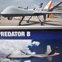 Important part: A Predator B drone, manufactured by General Atomics Aeronautical Systems Inc., is displayed at the company’s stand at the Paris Air Show in Paris in June. Despite President Barack Obama’s desire to shift the U.S.’ drone strike campaign to the Defense Department, the CIA is still behind the vast majority of hits. Despite Obama's plan to shift drone campaign, CIA still behind strikes
