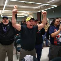 Up in arms: Boeing machinists celebrate in Seattle on Wednesday after voting to reject a contentious contract proposal that would have exchanged concessions for decades of secure jobs, at the city’s International Association of Machinists union hall. The offer was rejected by 67 percent of those polled Boeing may move 777X production out of Washington state