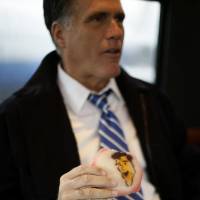 Healthy diet?: Former Massachusetts Gov. Mitt Romney eats a cookie made in his likeness on his campaign bus en route to Celina, Ohio, in October 2012, during his unsuccessful White House run.  | AP