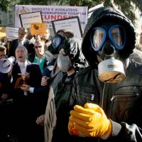 No masking their intentions: Albanian environmental activists protest in the capital, Tirana, on Nov. 7 against the prospect of using Albania as a site for destroying Syria\'s chemical weapons stockpile. | AFP-JIJI