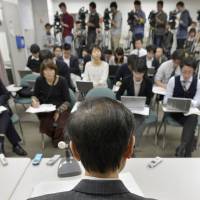 Winner: A 66-year-old plaintiff faces reporters during a news conference after the Osaka District Court ruled Monday that it is unconstitutional to set any age difference between widows and widowers for pension entitlement. | KYODO