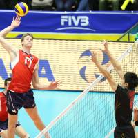 Standing tall: Maxwell Holt of the United States hits the ball against Japan during the FIVB Men\'s Grand Champions Cup on Tuesday at Kyoto Prefectural Gymnasium. Team USA defeated Japan 25-17, 25-17, 21-25, 25-20 | FIVB