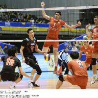 Over and out: Japan (in black) takes on Iran during their Grand Champions Cup match in Tokyo on Sunday. Iran won in straight sets. | KYODO