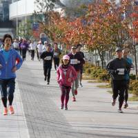 On the run: Participants in the Jogging Matsuri enjoy a lap round Yokohama Minato Mirai Sports Park. | AP
