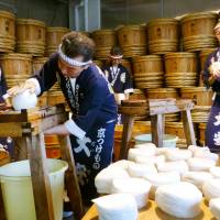 Workers at pickle-maker Daiyasu slice pickled daikon Thursday at a factory in the city of Kyoto. Production of \"senmaizuke\" pickles is at its peak. | KYODO