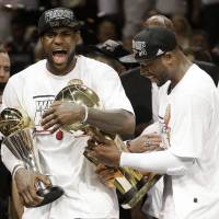 It’s getting hot in here: Miami Heat stars LeBron James (left) and Dwyane Wade celebrate after beating the San Antonio Spurs in Game 7 of the NBA Finals to deliver the franchise a second consecutive championship. James took home a second straight Finals MVP in the process.  | AP