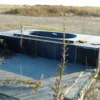 Exposed: A bathtub and concrete foundation are all that remain of a house on the unprotected coast in Sendai City, Miyagi Prefecture, after the March 11, 2011, tsunami. | STEPHEN HESSE PHOTO