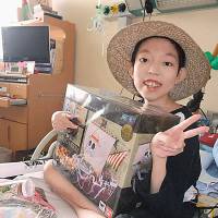 The gift of hope: A young girl poses for a photo after her wish was granted by Make-a-Wish of Japan. | COURTESY OF MAKE-A-WISH JAPAN