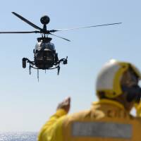 Moving in: An army helicopter lands on the USS Lake Erie on Dec. 9. U.S. Army seeks bigger Pacific role