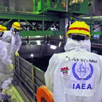 In deep water: Experts from the International Atomic Energy Agency, the U.N. nuclear watchdog, conduct an inspection of the Fukushima No. 1 plant on Nov. 27. IAEA says Tepco should consider water release