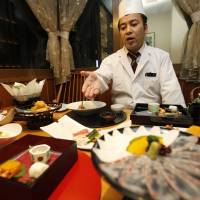 \"Washoku\' reigns supreme: Kenji Uda, the head chef at Irimoya Bettei restaurant in Tokyo, serves up some fancy fare Nov. 27. | AP