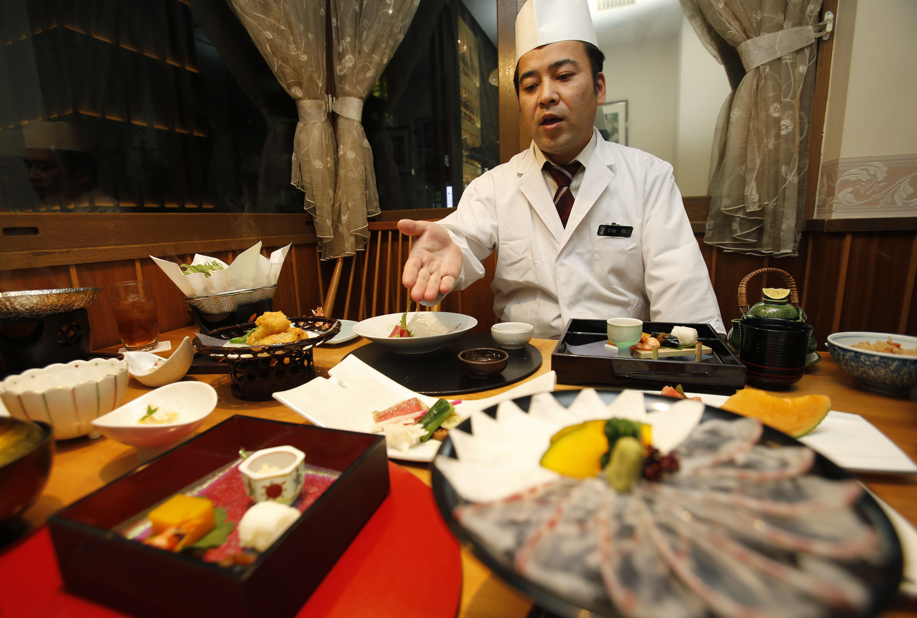 'Washoku' reigns supreme: Kenji Uda, the head chef at Irimoya Bettei restaurant in Tokyo, serves up some fancy fare Nov. 27. | AP