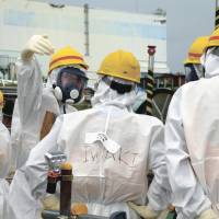 Eyes open: The Fukushima No. 1 plant is inspected Sept. 25. Water from fire trucks didn't reach Fukushima No. 1 reactor cores: Tepco