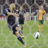 First past the post: Keisuke Honda  scores a penalty in injury time at Saitama Stadium in June to give Japan a 1-1 draw with Australia, making the Blue Samurai the first team to qualify for the 2014 World Cup.   | KYODO