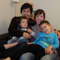 Settled in: Toru and Michelle Takahashi pose for a photo with their two boys, Colton (left) and Keiden, at their home in Kodaira, western Tokyo. For Canadian traveler, last-minute meeting led to change of heart and new start in Japan