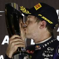 Formula One drivers probably wished there was something that could’ve kept Sebastian Vettel away, as they watched the German kiss the trophy after clinching a fourth straight F1 crown with a win in the Abu Dhabi Grand Prix. | AP