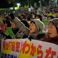 Against all odds: Protesters voice their opposition against the state secrets bill outside the Diet on Friday night. | AFP-JIJI