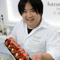 Mouth-watering: Pastry chef Kazunori Ikeda, who runs a sweets store in Sendai selling products using strawberries, shows off some tarts made with locally grown fruit. | KYODO