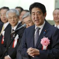 Market mover: Prime Minister Shinzo Abe speaks at a ceremony Monday to wrap up 2013 trading on the Tokyo Stock Exchange. | AP