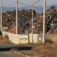 Fire hazard: Piles of mixed scrap rise from the dock at Mikawa port in Toyohashi, Aichi Prefecture, in November. Fires thrive along with exports of scrap
