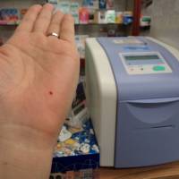 Just a pinprick: A customer performs an easy blood test to check for diabetes at Ayase Pharmacy in Adachi Ward, Tokyo. Simple tests fill health-check gaps