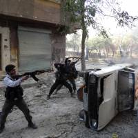 Under fire: Syrian opposition fighters clash with pro-regime forces in Aleppo on Oct. 9. U.S. officials say some Americans, such as North Carolina resident Basit Javed Sheikh, are joining Syria’s ongoing civil war and could pose a security risk on their return home. Americans drawn by Syrian civil war could create security risk upon return